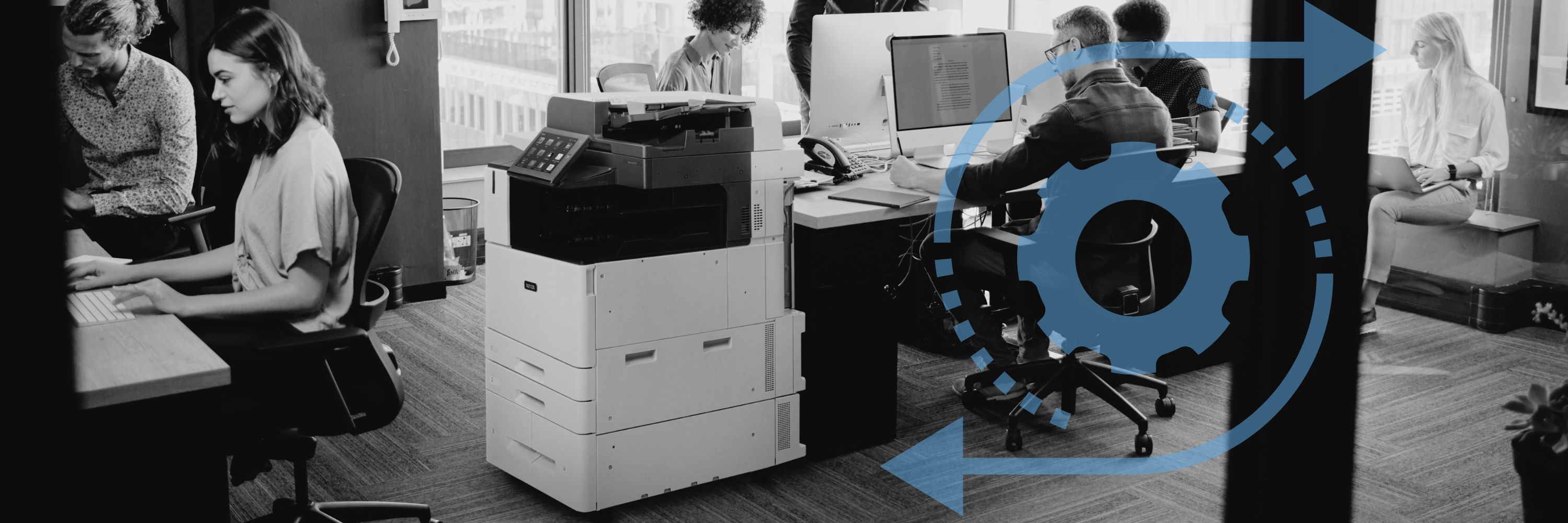 A workgroup in an office working next to a Xerox printer