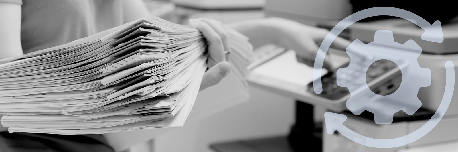 Woman with a stack of papers near a printer