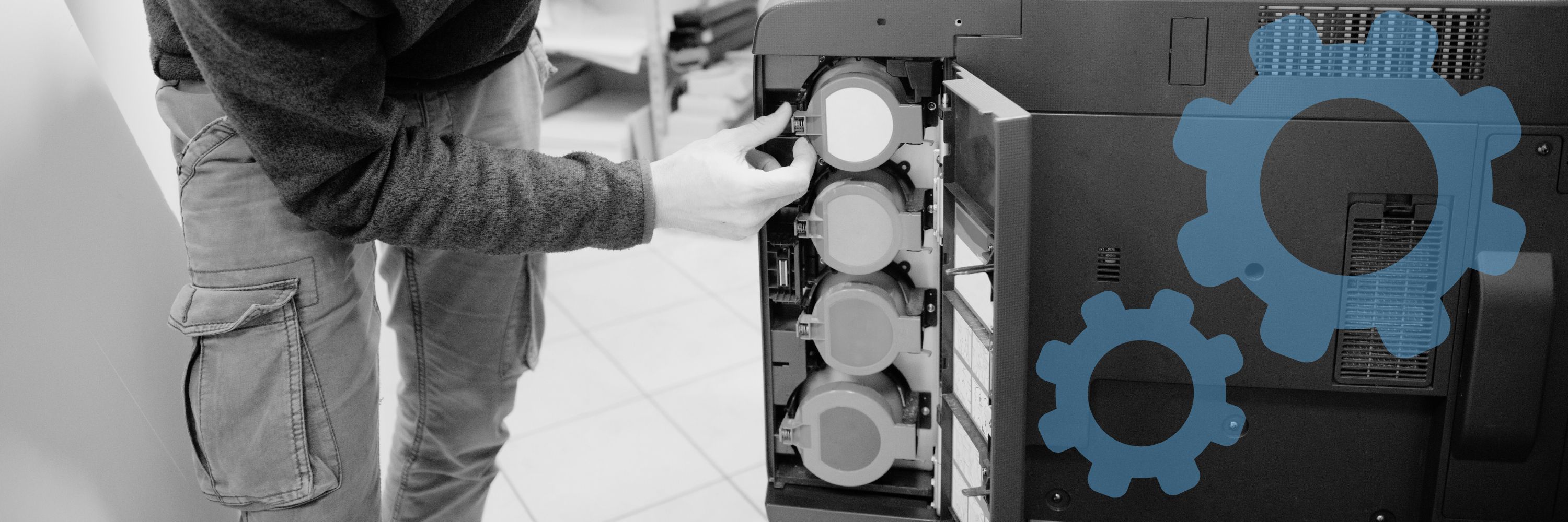 A man replacing printer cartridges