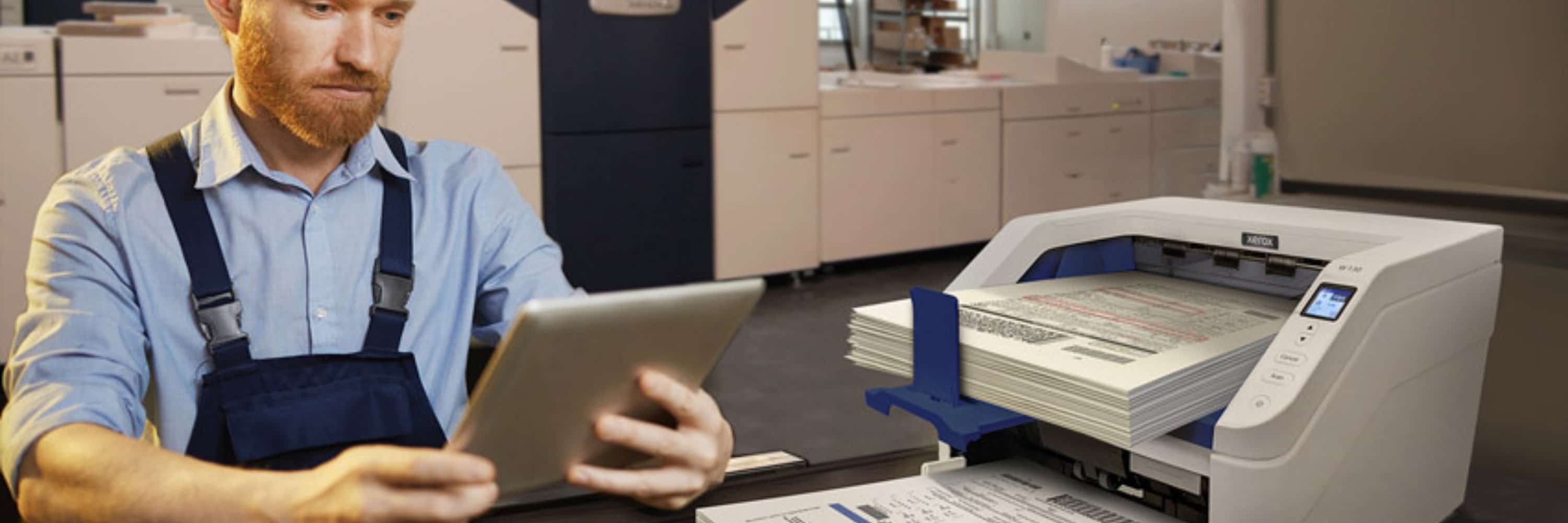 Man on a tablet next to a Xerox scanner