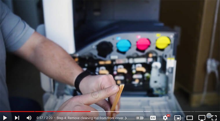 Printer technician points to u-shape on cleaning rod on Xerox VersaLink C7000 Series printer
