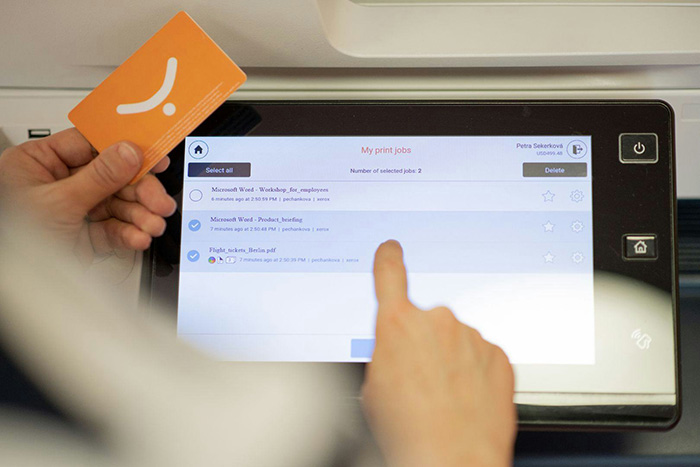 Woman authenticates at the printer using card