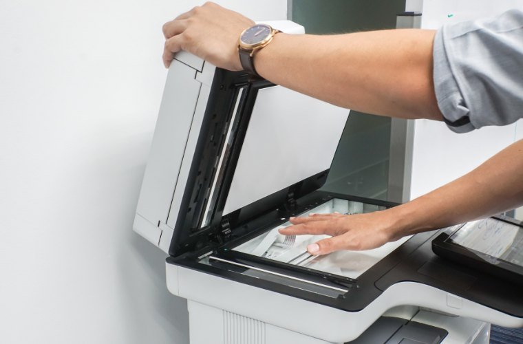 Man Opening a Printer to Scan Document