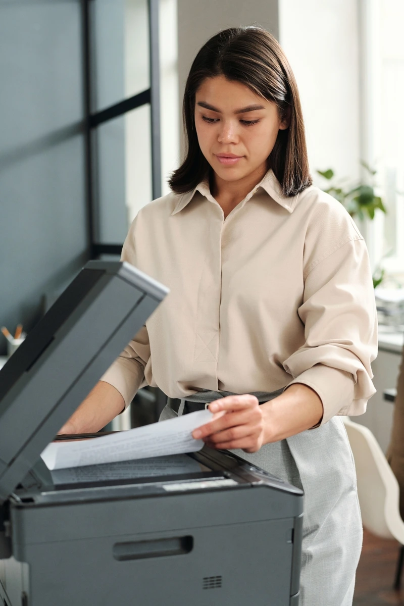 Professional using an office scanner for document management