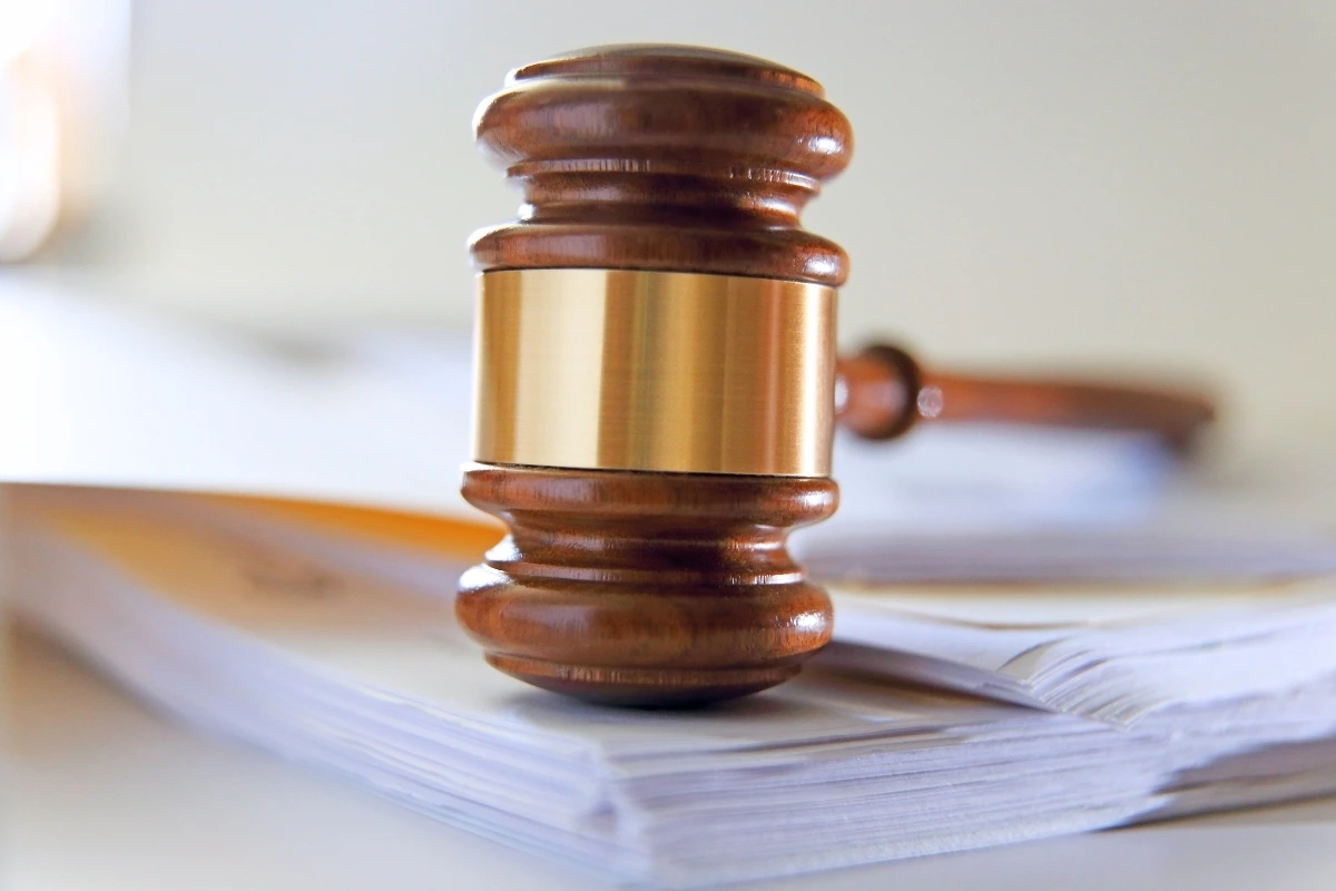 Judge's gavel resting on stack of legal documents