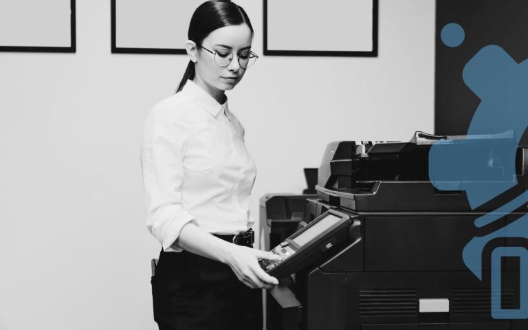 A woman using a printer in an office setting