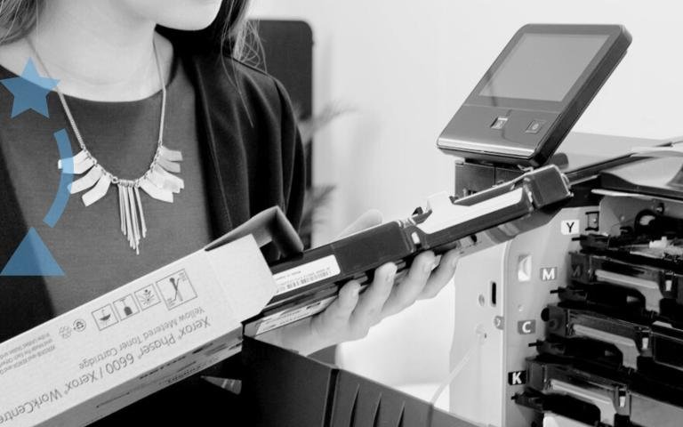 A woman holding printer toner cartridges