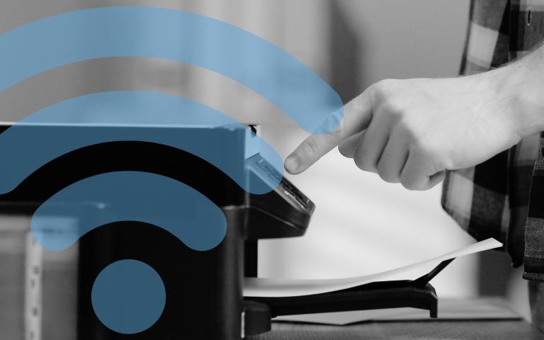 Man's hand pressing a button on a home printer