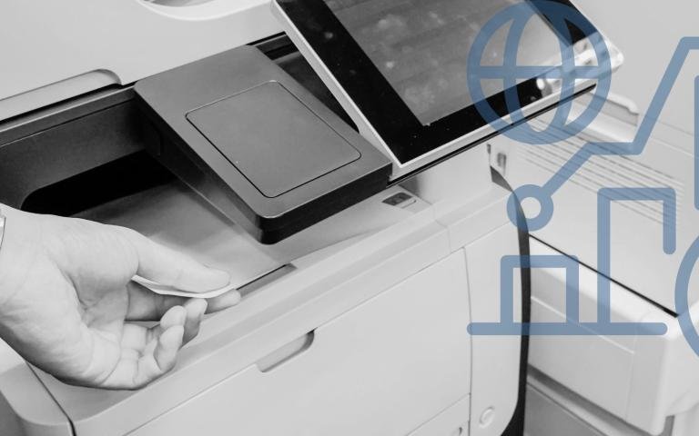 Person using a laser printer in an office