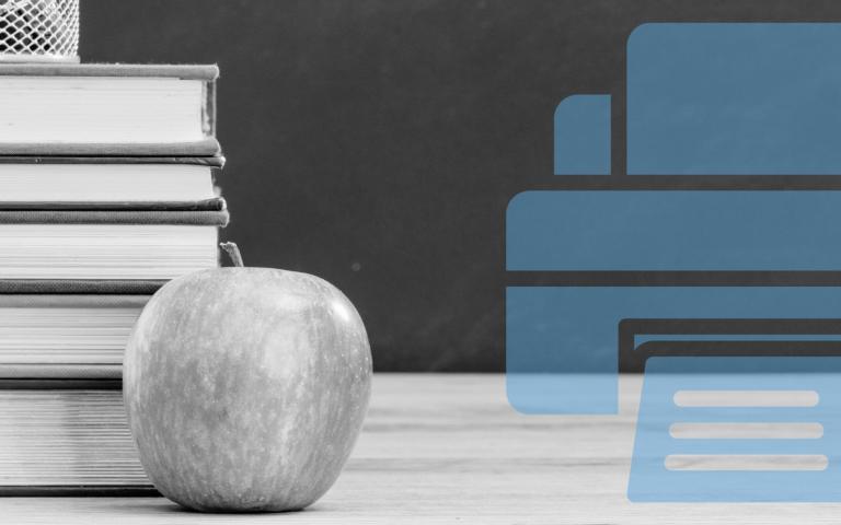 A school blackboard and a desk with an apple and books