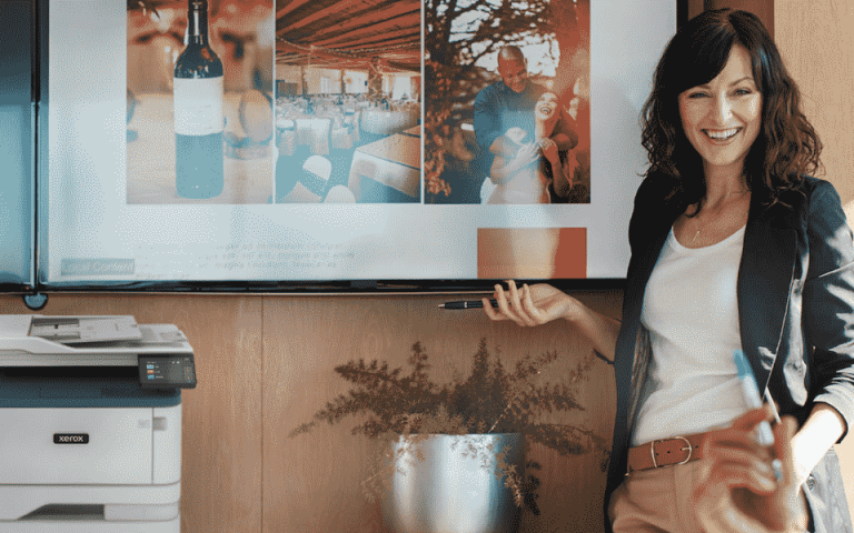 A group of people talking with the Xerox B305 in the background