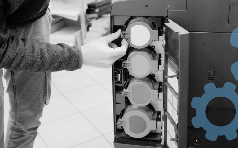 A man replacing printer cartridges