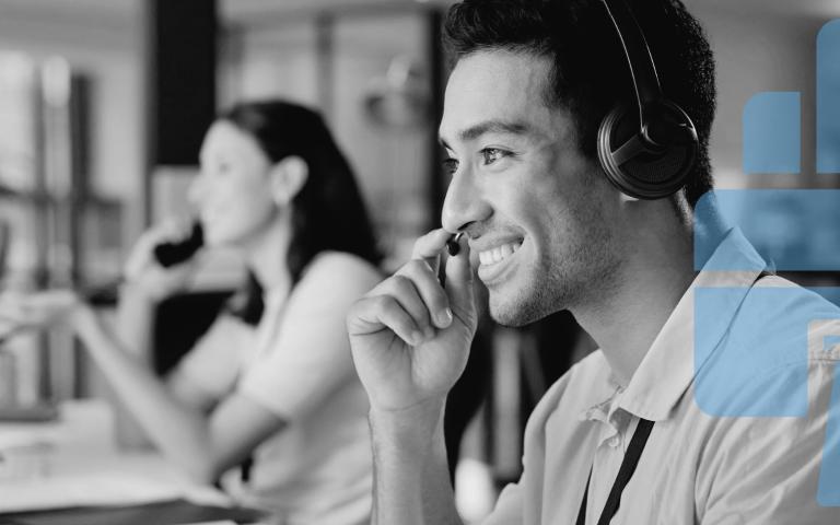 A man doing remote customer support in front of a computer