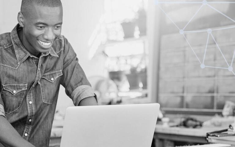 A person on a laptop in a work station