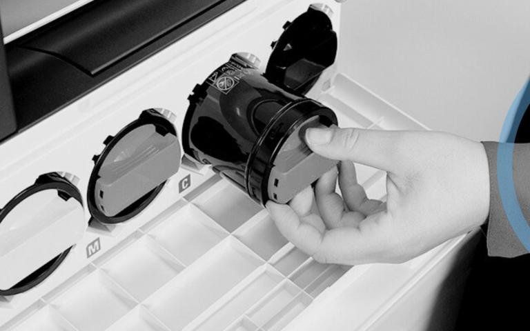 Person taking toner out of printer