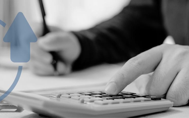 Man calculating bills with pen and calculator