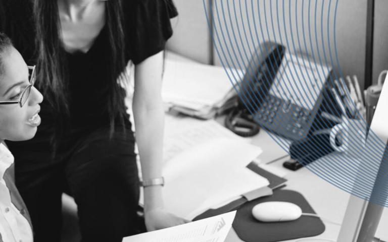 Workers working in front of a computer