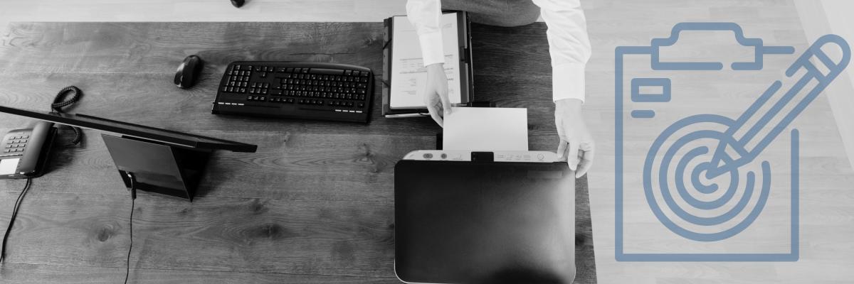 Woman getting a document from a printer on a desk