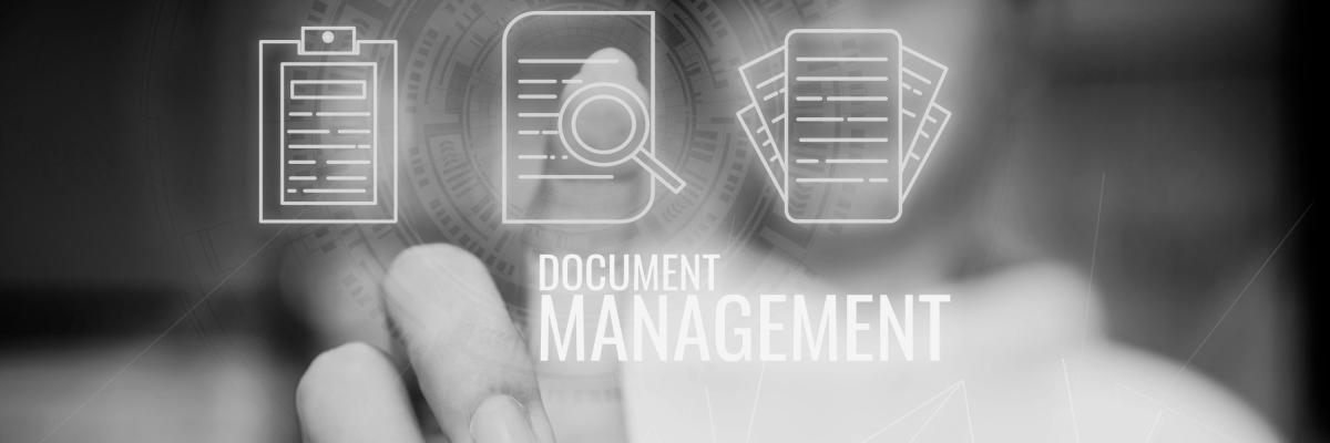 grayscale photo of hand pointing to paper graphic with words document management