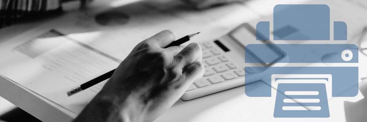 A person on a desk using a calculator