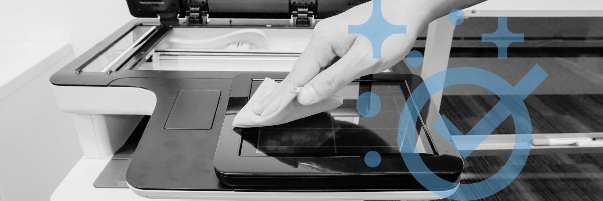 Person using a cloth to clean the glass on a printer