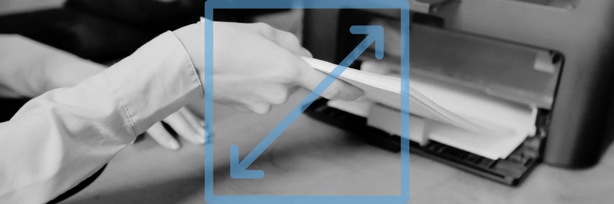 Woman putting paper onto printer