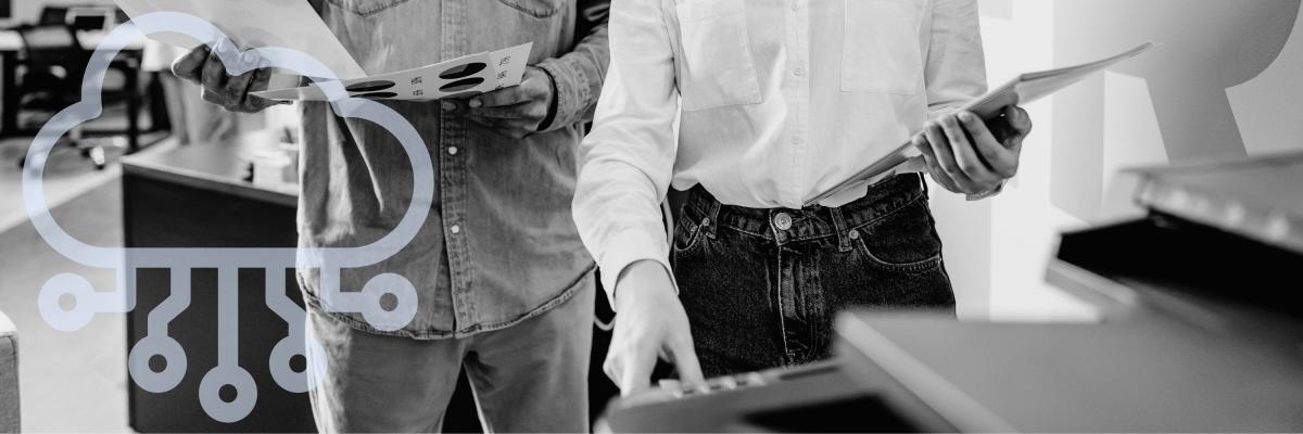 Two office workers using a printer