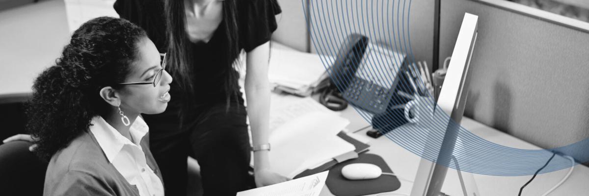 Workers working in front of a computer