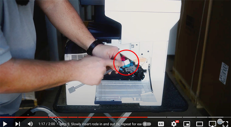 Printer technician points out white felt cloth on gray cleaning rod of Xerox VersaLink C400/C405