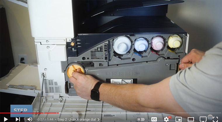 Printer technician unlocks orange dial on waste toner transport assembly of Xerox B8100/C8100