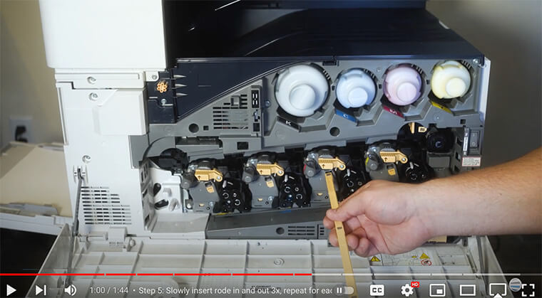Printer technician cleans drum lenses on Xerox B8100/C8100