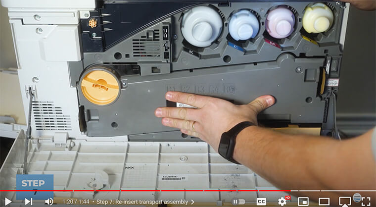 Printer technician re-inserts transport assembly on Xerox B8100/C8100
