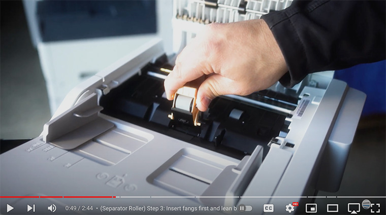 Printer technician reinstalls separator roll on Xerox VersaLink C410/C415