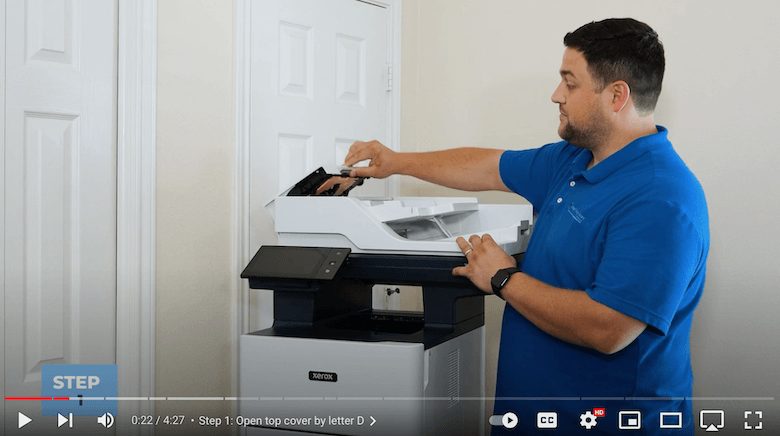 A printer technician opens the top cover on the Xerox VersaLink B625