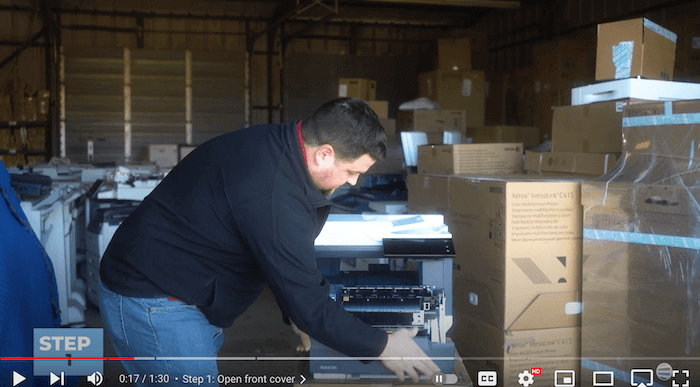 Printer technician opens the front cover of the Xerox C410/C415 to replace the toner