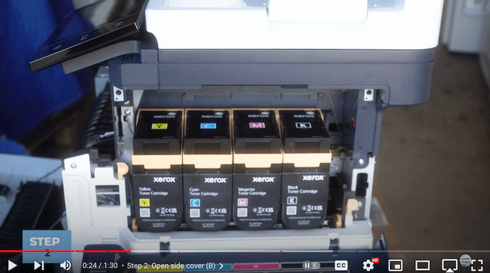 Printer technician opens the side cover of the Xerox C410/C415 to replace the toner