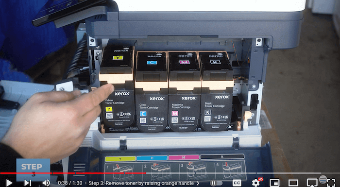 Printer technician removes toner on the Xerox C410/C415 to replace the toner