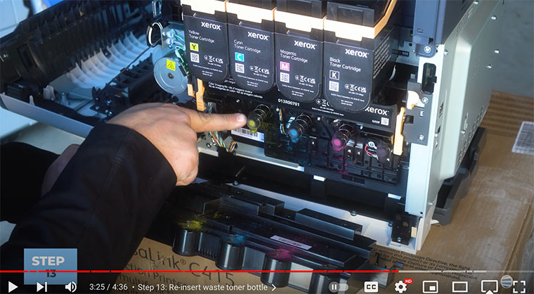 Printer technician points out springs to re-insert waste toner bottle on the Xerox VersaLink C410/C415