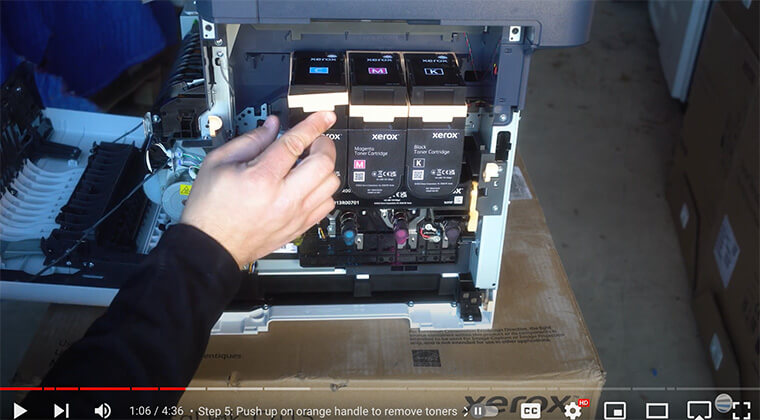 Printer technician removes toner cartridges from Xerox C410/C415 printer