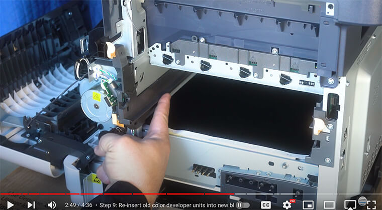 Printer technician points out grey slot for new imaging unit on the Xerox VersaLink C410/C415