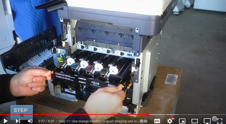 Printer technician inserts new imaging unit on Xerox VersaLink C410/C415