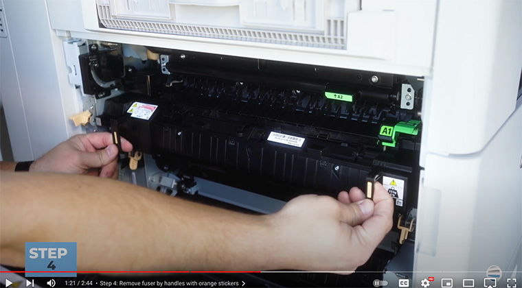 Printer technician removes fuser on Xerox AltaLink printer
