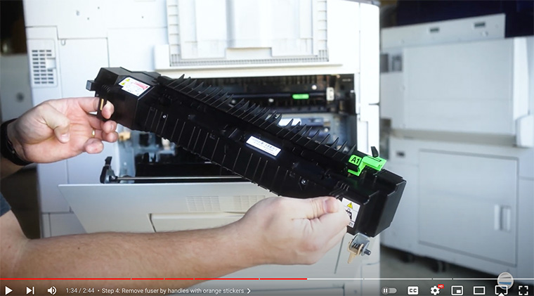 Printer technician grabs new fuser for the Xerox AltaLink printer