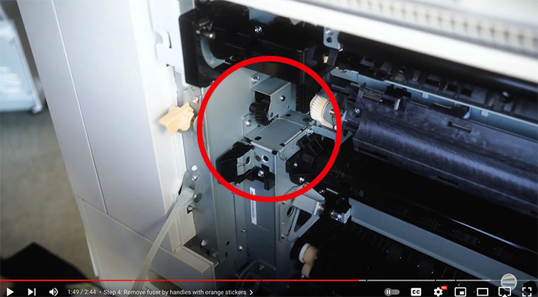 Printer technician points out metal shelves inside the Xerox AltaLink printer