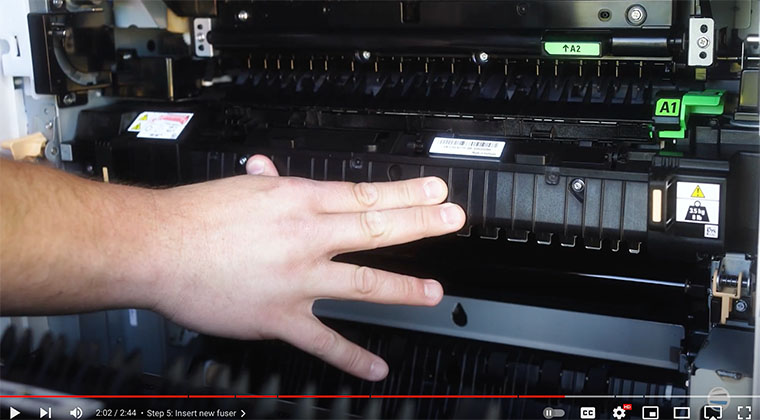 Printer technician inserts new fuser on the Xerox AltaLink printer