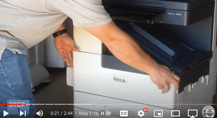 Printer technician opens the front cover on the Xerox AltaLink B8090 Printer to replace print cartridge