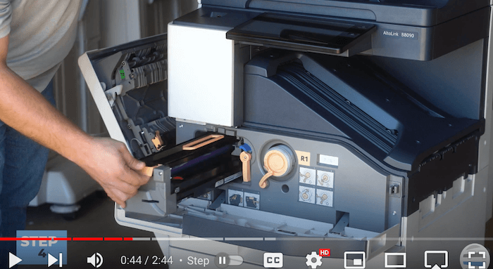 Printer technician pulls out the cartridge on the Xerox AltaLink B8090 Printer to replace print cartridge