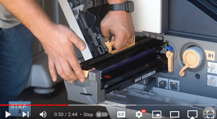 Printer technician lifts the cartridge on the Xerox AltaLink B8090 Printer to replace print cartridge