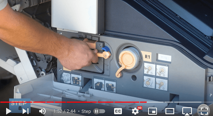 Printer technician locks the orange latch on the Xerox AltaLink B8090 Printer after replacing print cartridge