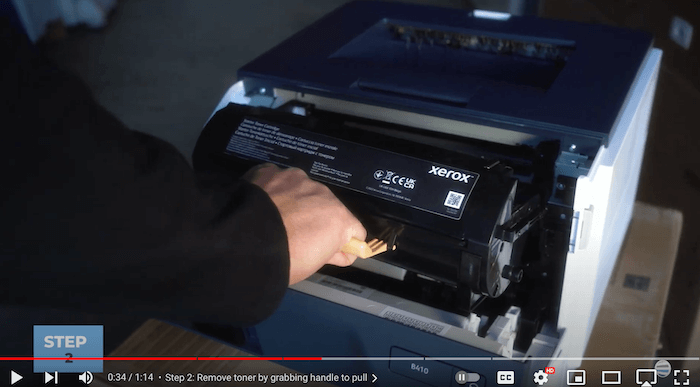 Printer technician removes the old toner cartridge on the Xerox B410/B415 printer to replace the toner